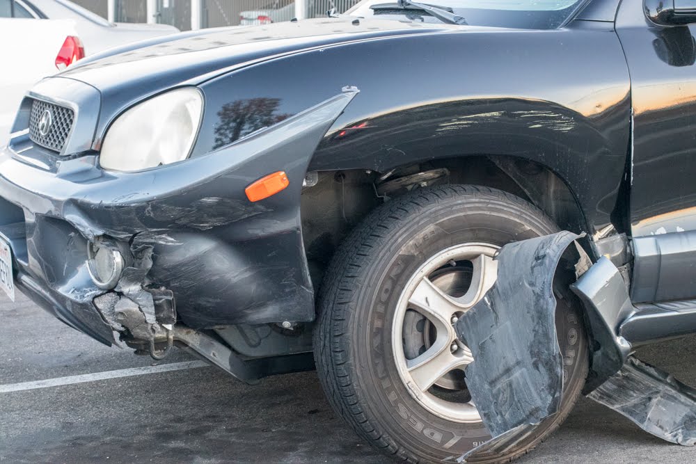 Vehicle Hits Building, Hurts Two Near Center St